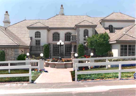 Milgard fiberglass wood clad round top windows in large house